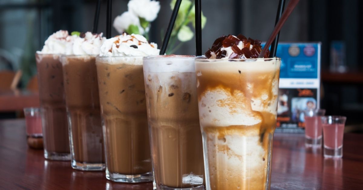 Three cold coffee drinks side by side showing iced coffee, cold brew, and nitro cold brew