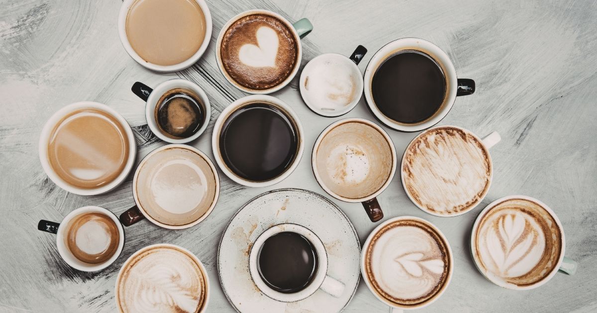 Four Starbucks seasonal drinks representing spring, summer, fall, and winter arranged in a row